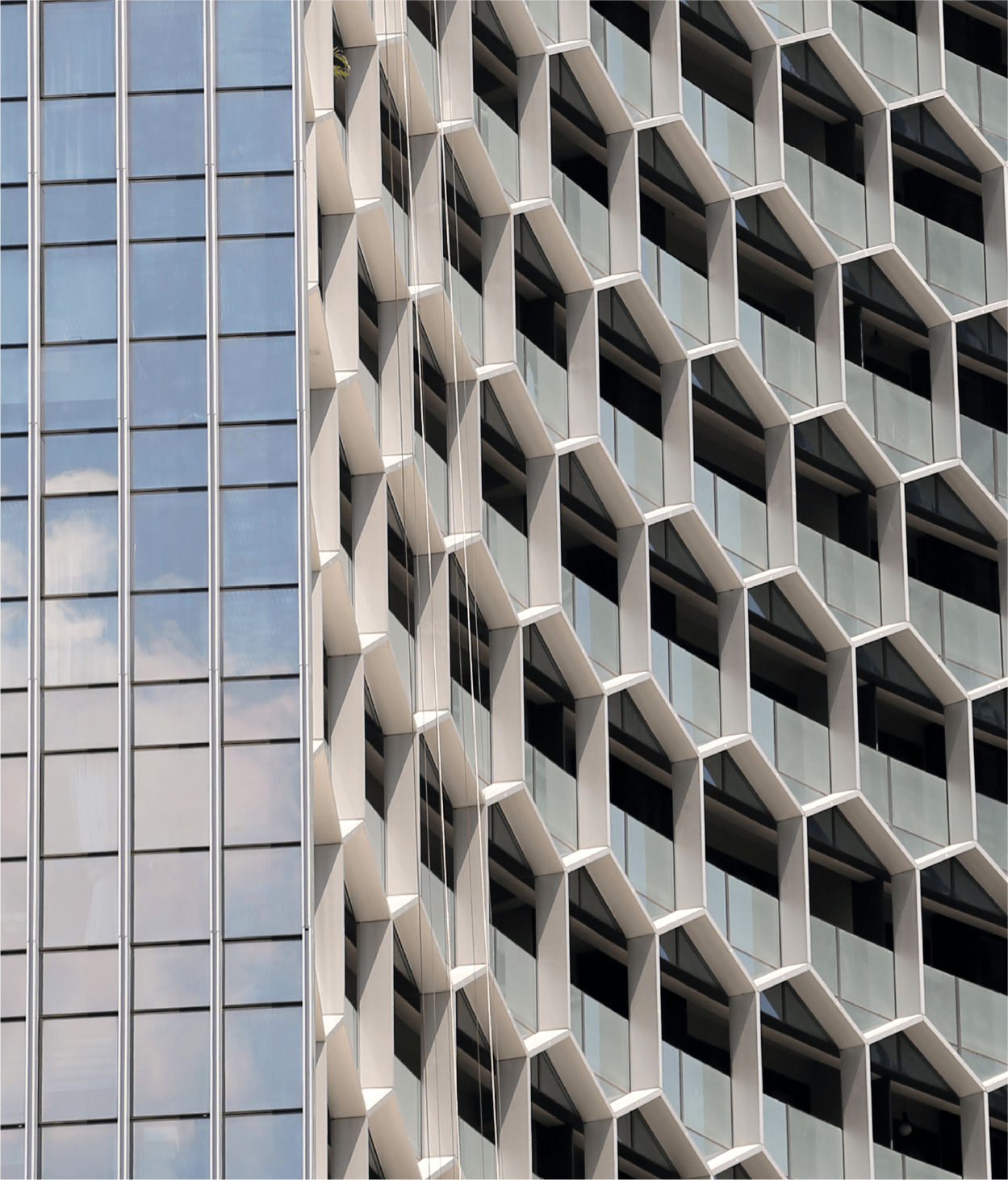 Curved office building façade with hexagonal frames over the windows.